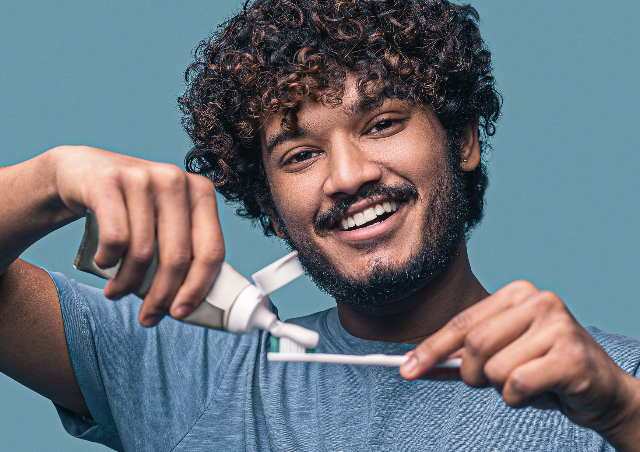 Person brushing teeth with joy